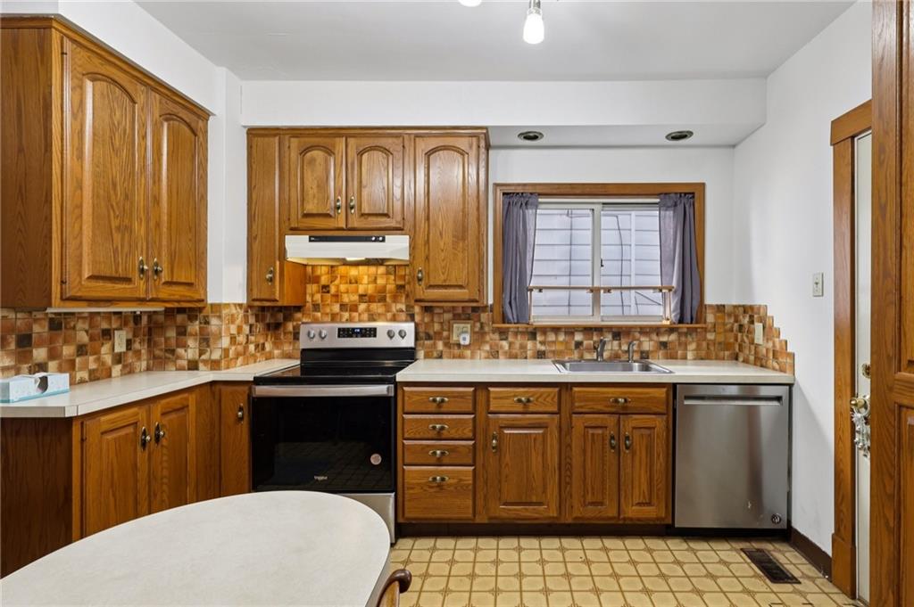 1910 Ridge Avenue New Kensington, PA 15068 - Photo 15 of 50 a kitchen with a sink stove and cabinets