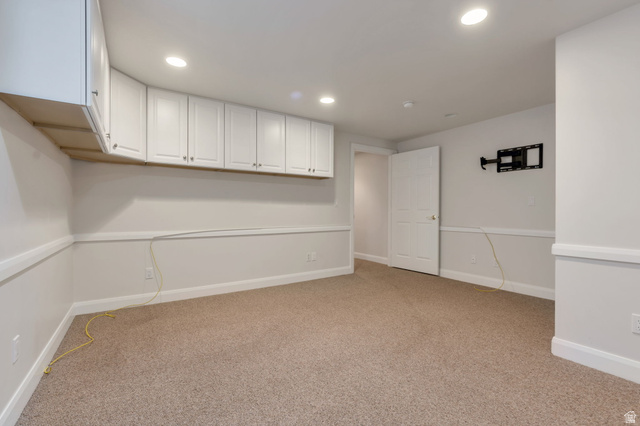 1092 Tithing Ridge Drive Riverton, UT 84065 - Photo 20 of 25 Recessed lighting illuminates this carpeted room featuring extensive white upper cabinetry, white baseboards, and white chair rail molding OR BEDROOM extensive storage in this area