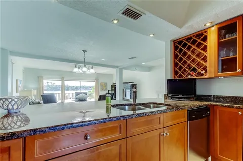 a kitchen with granite countertop a sink a stove and cabinets