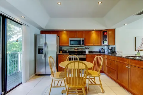 a kitchen with stainless steel appliances granite countertop a sink and a stove