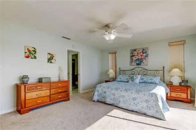 a bedroom with a large bed and a flat tv screen