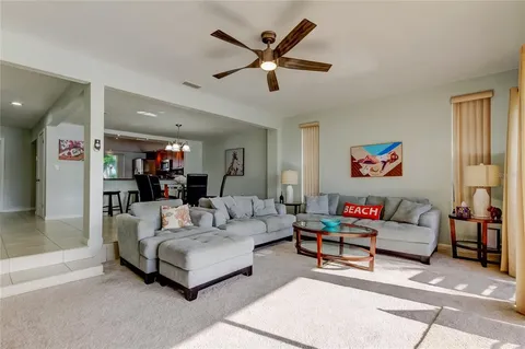 a living room with furniture and kitchen view