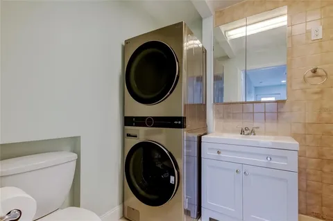 a bathroom with a sink a mirror a glass door shower and vanity