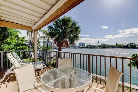 a view of a chair and tables the patio