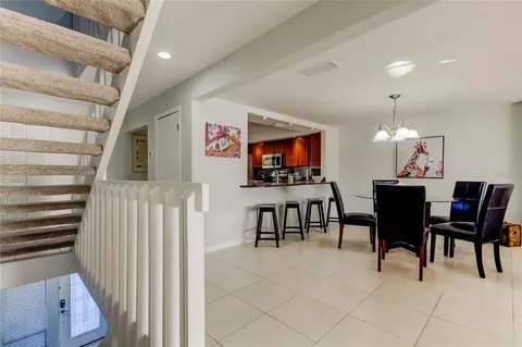 a dining room with furniture and a flat screen tv