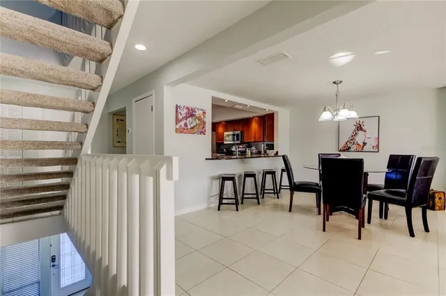 a dining room with furniture and a flat screen tv