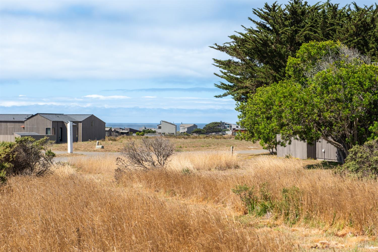 41934 Leeward Road The Sea Ranch, CA 95497 - Photo 6 of 10 a view of a lake with a house in the background