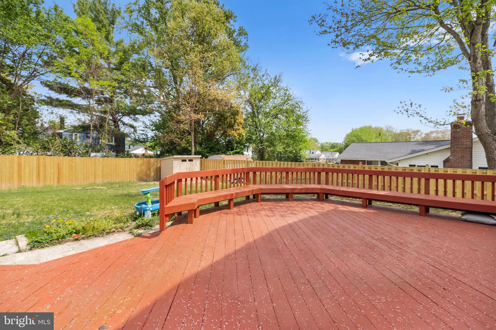 7402 Dunston Street Springfield, VA 22151 - Photo 34 of 37 a view of a yard with wooden fence and trees