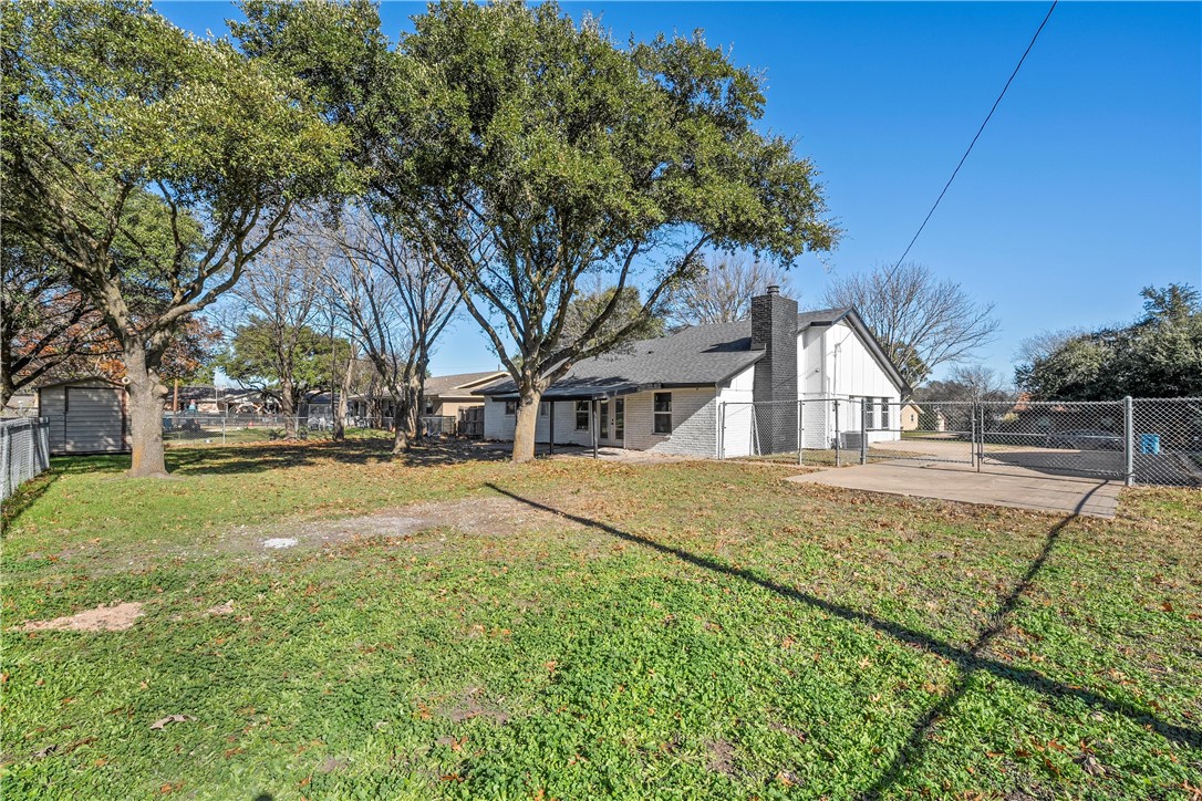 337 Travis Lane Hewitt, TX 76643 - Photo 20 of 22 a view of garage yard and tree