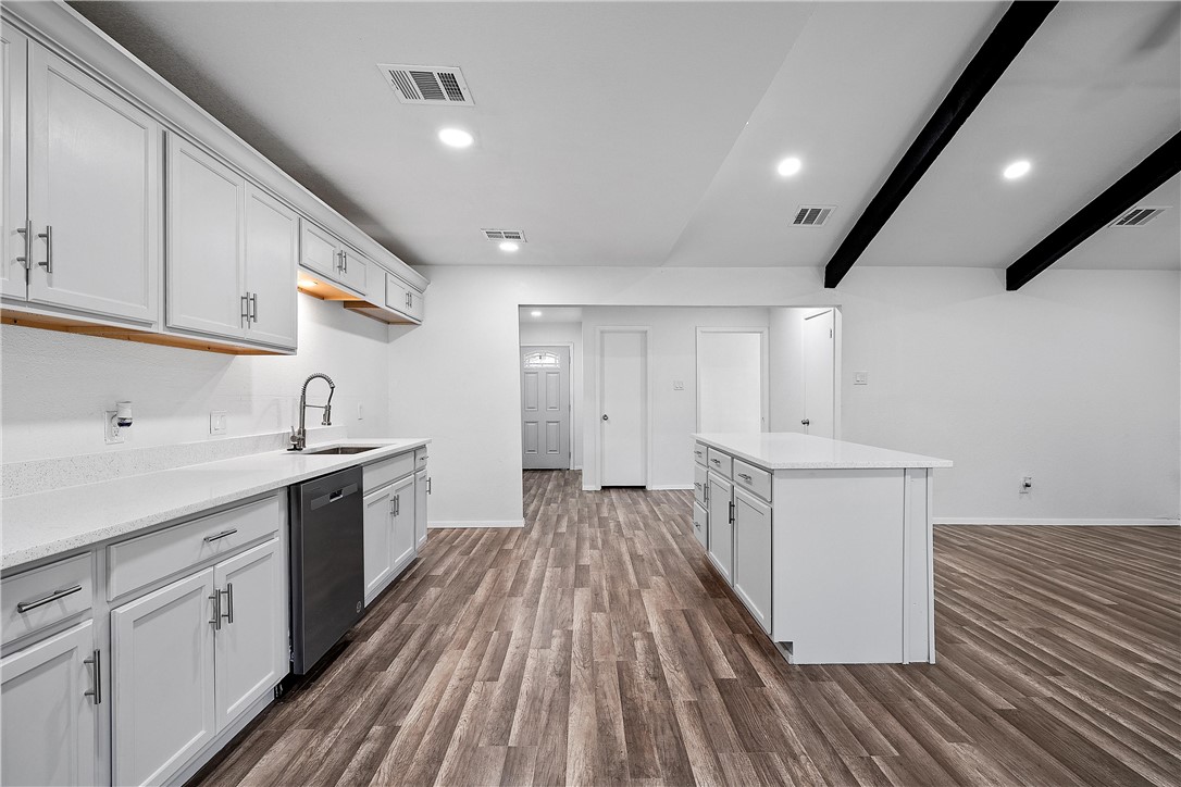 337 Travis Lane Hewitt, TX 76643 - Photo 4 of 22 a kitchen with wooden cabinets and sink