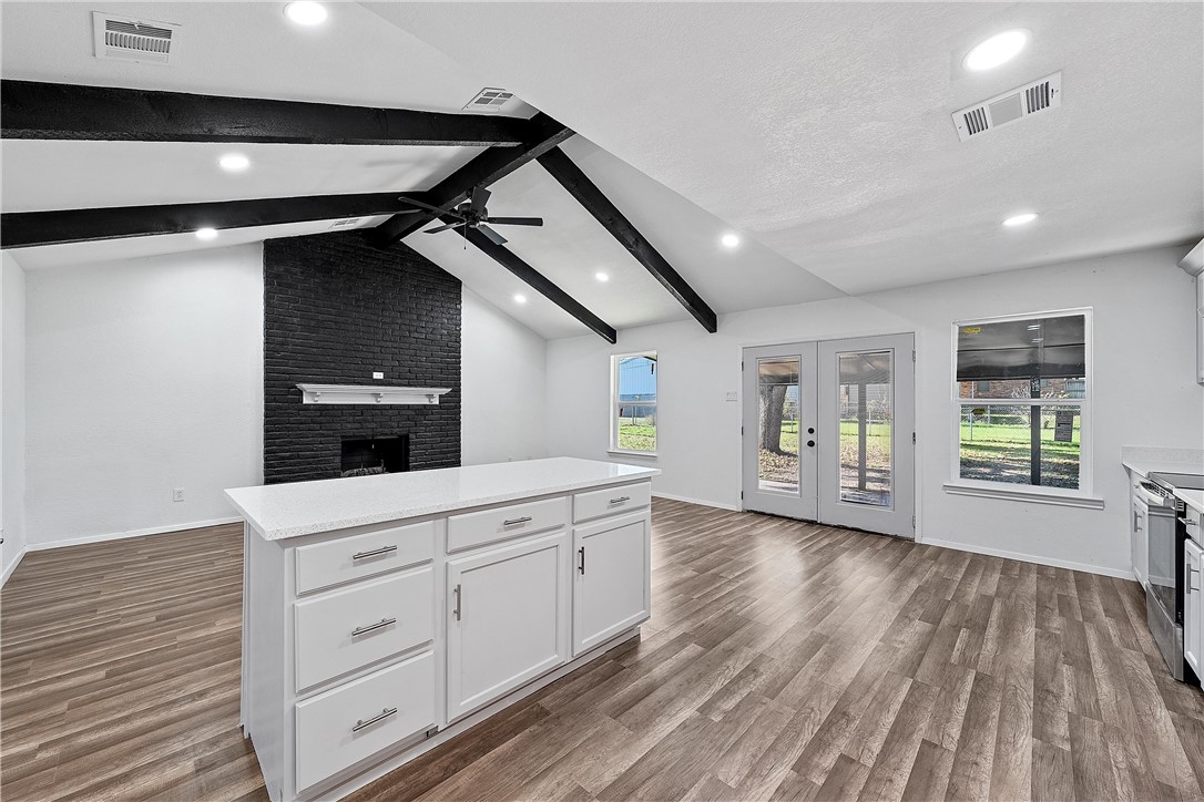 337 Travis Lane Hewitt, TX 76643 - Photo 5 of 22 a kitchen with a wooden floor and cabinets