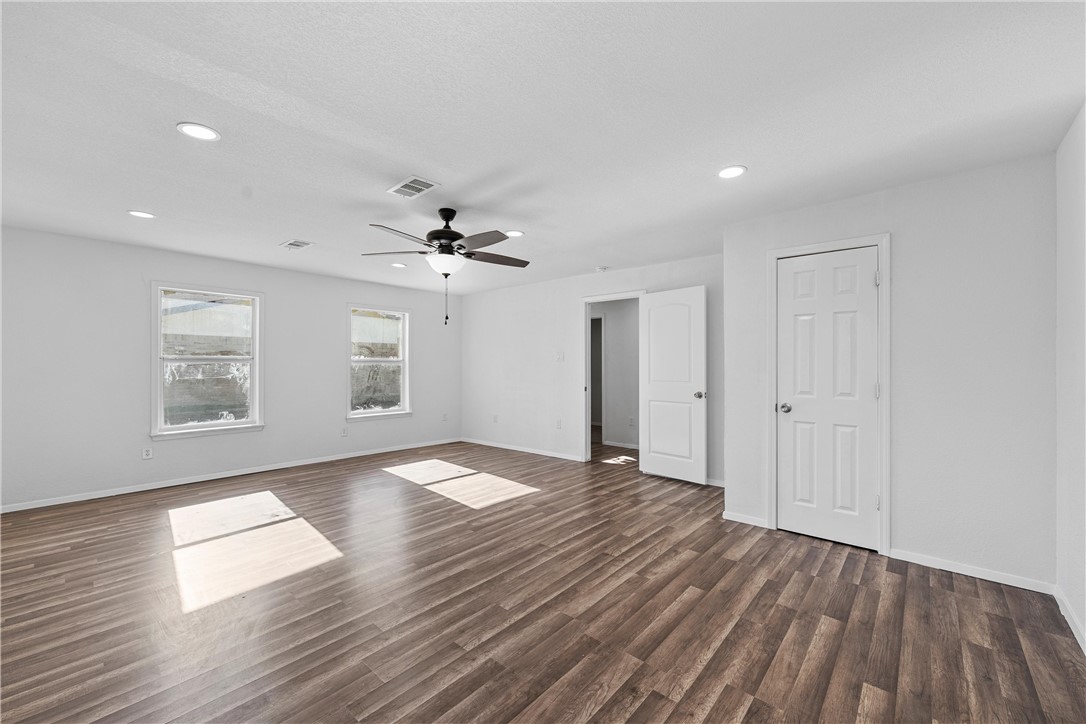 337 Travis Lane Hewitt, TX 76643 - Photo 8 of 22 an empty room with wooden floor chandelier and windows