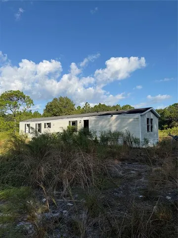 a view of a lake with houses in back