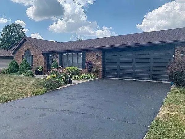 a view of a house with a yard and garage