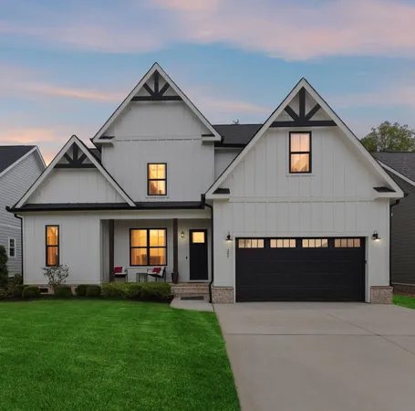 a front view of a house with a yard and garage