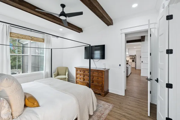 a view of a room with wooden floor and ceiling fan