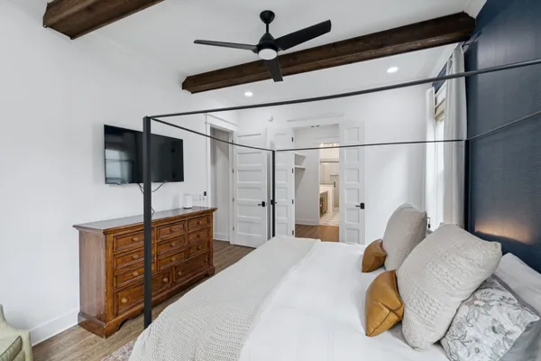 a bedroom with a bed and a flat screen tv