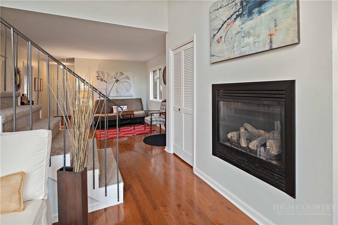 265 Leatherwood Road Banner Elk, NC 28604 - Photo 16 of 42 a view of a livingroom with wooden floor and a fireplace