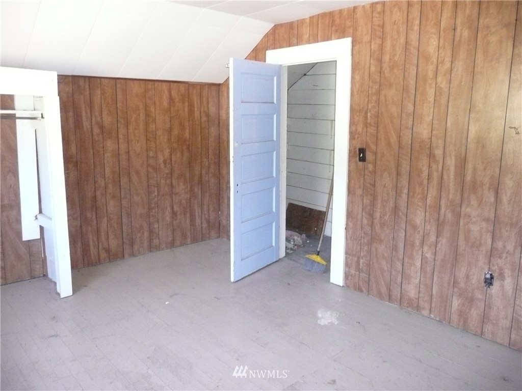 167 Yenter Road Republic, WA 99166 - Photo 4 of 11 a view of an empty room with a wooden door