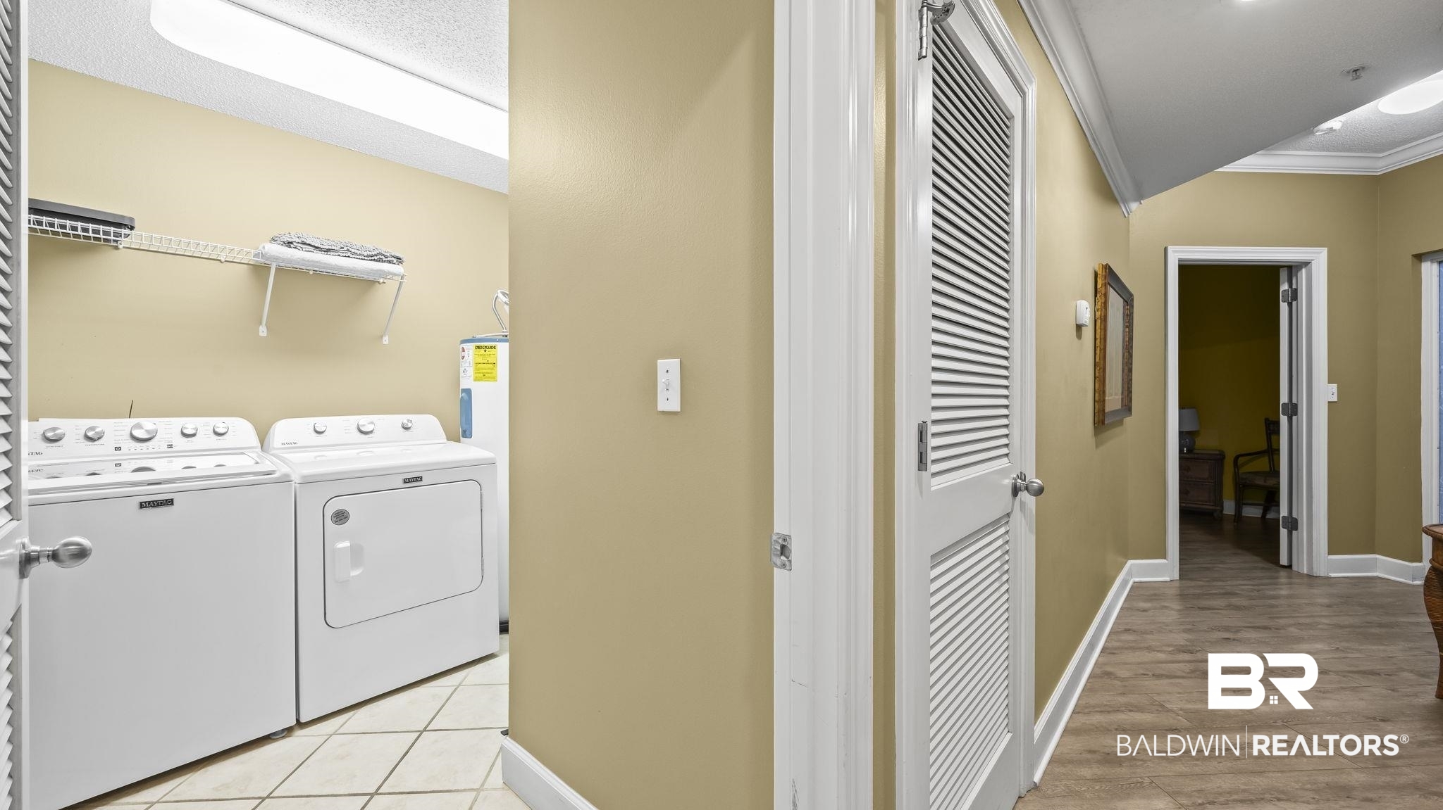 27580 Canal Road, Unit 214 BS 62 Orange Beach, AL 36561 - Photo 15 of 23 Laundry room featuring separate washer and dryer, ornamental molding, water heater, and light tile patterned floors