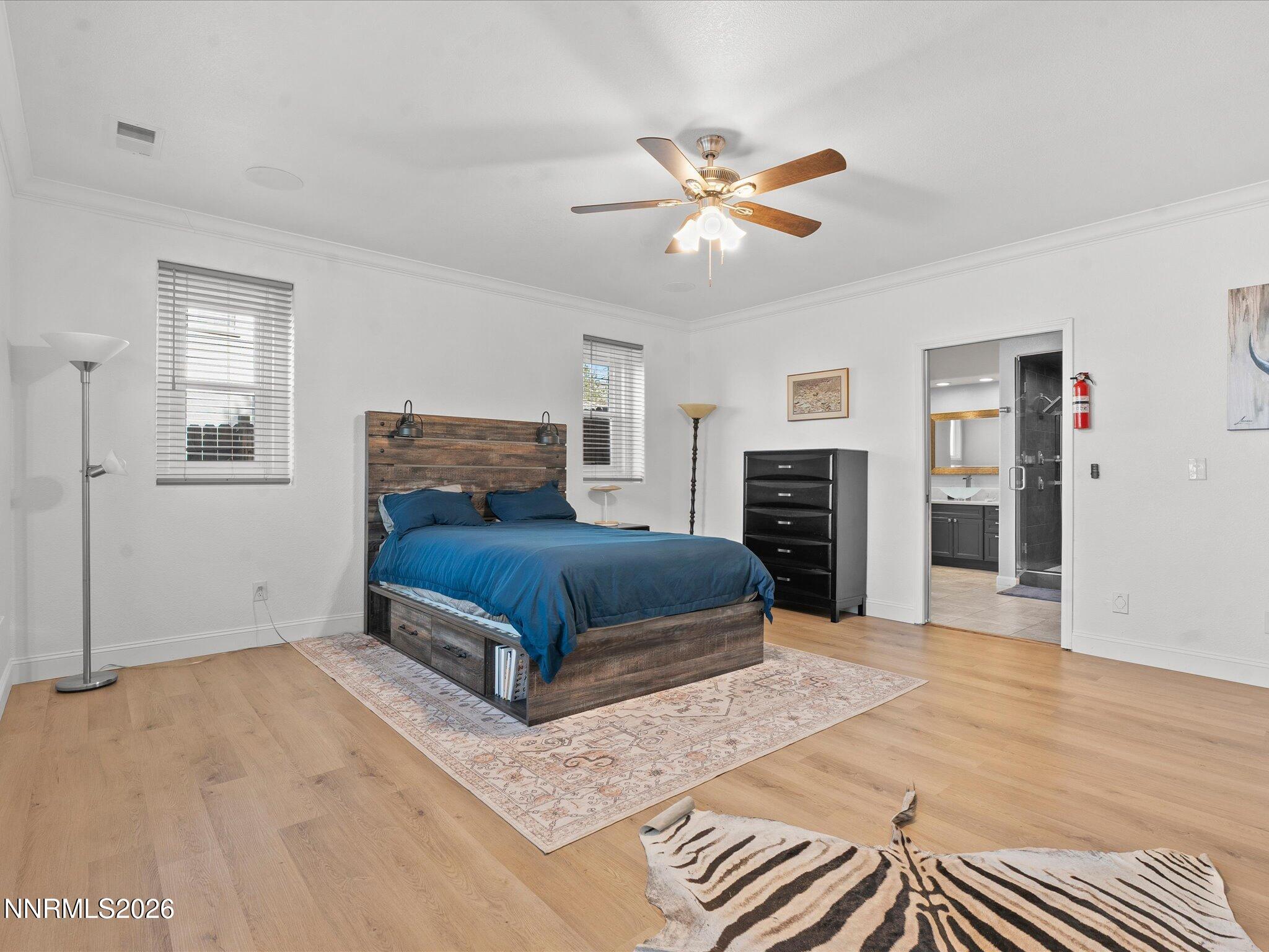 4943 Foxcreek Trail Reno, NV 89519 - Photo 11 of 26 a bedroom with a large bed and a chandelier