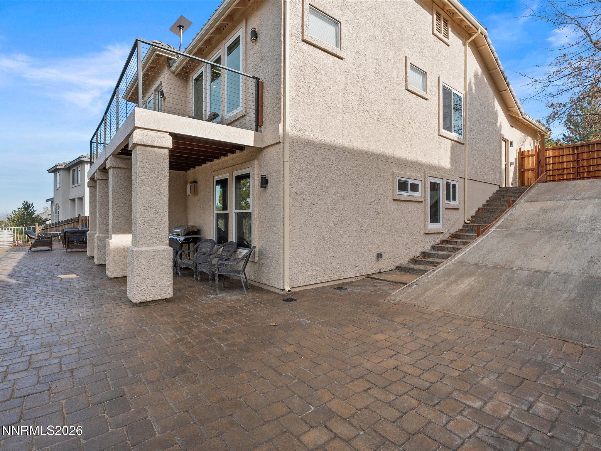 4943 Foxcreek Trail Reno, NV 89519 - Photo 21 of 26 a view of a house with a barbeque and wooden stairs