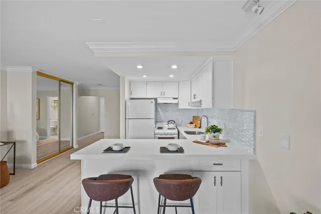 a kitchen with kitchen island a stove a table and chairs
