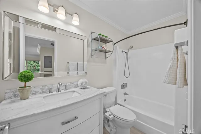a bathroom with a granite countertop sink a toilet and a mirror