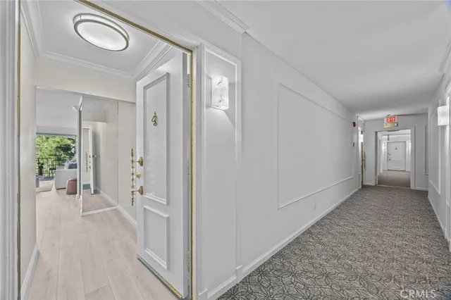 a view of a hallway with wooden floor and closet area