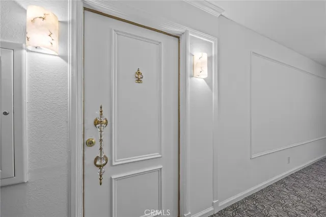 a view of a kitchen with fridge and wooden floor