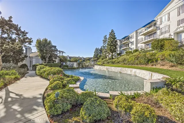 a view of swimming pool with outdoor seating and plants