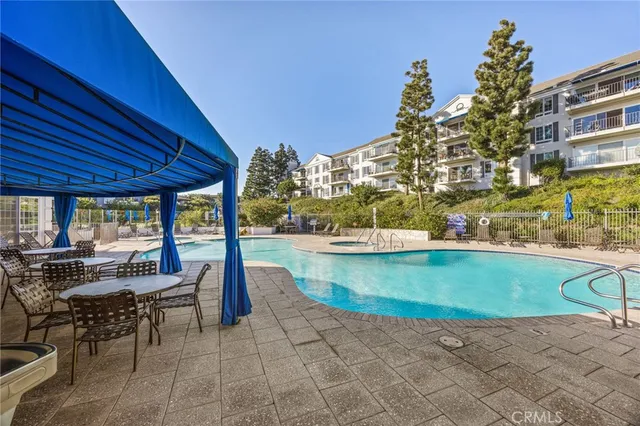 a view of a swimming pool with outdoor seating