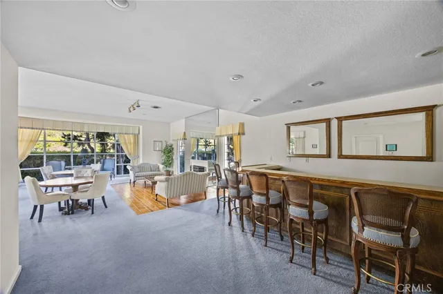 a living room with fireplace furniture and a large window