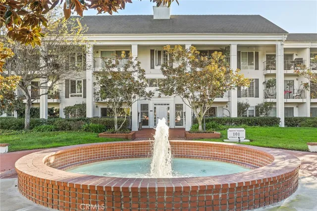 a sign board with buildings in the background