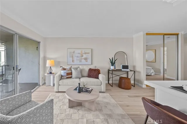 a living room with furniture a mirror and a potted plant