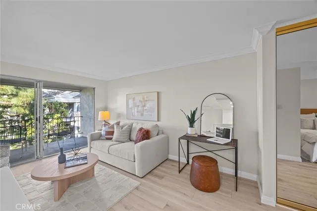 a living room with furniture a rug a fireplace and a floor to ceiling window