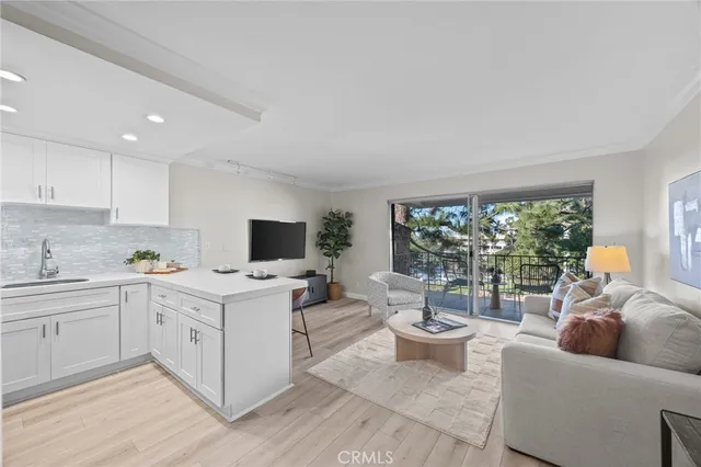 a living room with furniture a window and a flat screen tv
