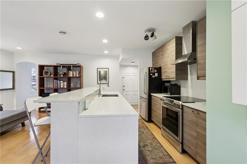 600 South Negley Avenue, Unit 16 Pittsburgh, PA 15232 - Photo 11 of 22 a large kitchen with stainless steel appliances granite countertop a sink and a stove