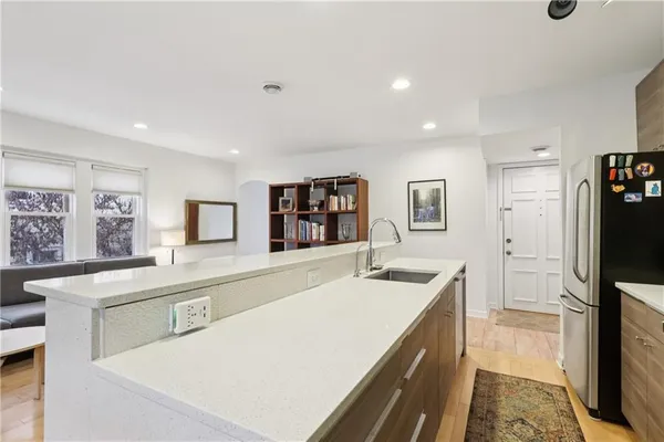 a kitchen with a sink and a refrigerator