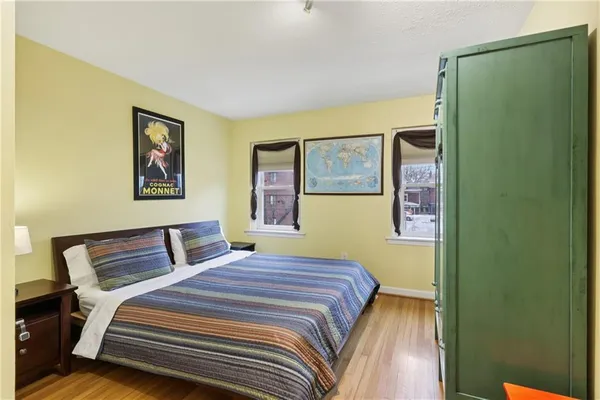 a bedroom with a bed and a painting on the wall