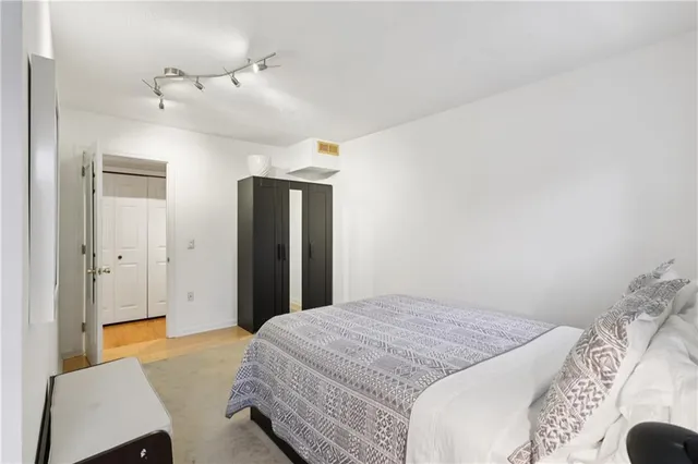 a bedroom with a bed and a chair