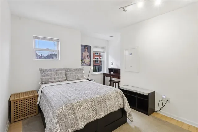 a bedroom with a bed and a couch