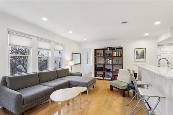 a living room with furniture and a book shelf
