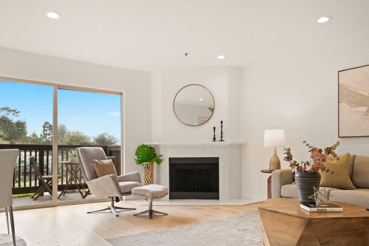 504 Monterey Road, Unit 14L Pacifica, CA 94044 - Photo 8 of 39 a living room with furniture a fireplace and a table
