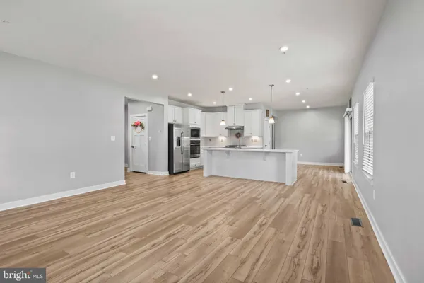 a view of kitchen with wooden floor and windows