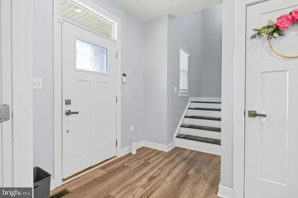 a view of a bedroom with wooden floor and stairs