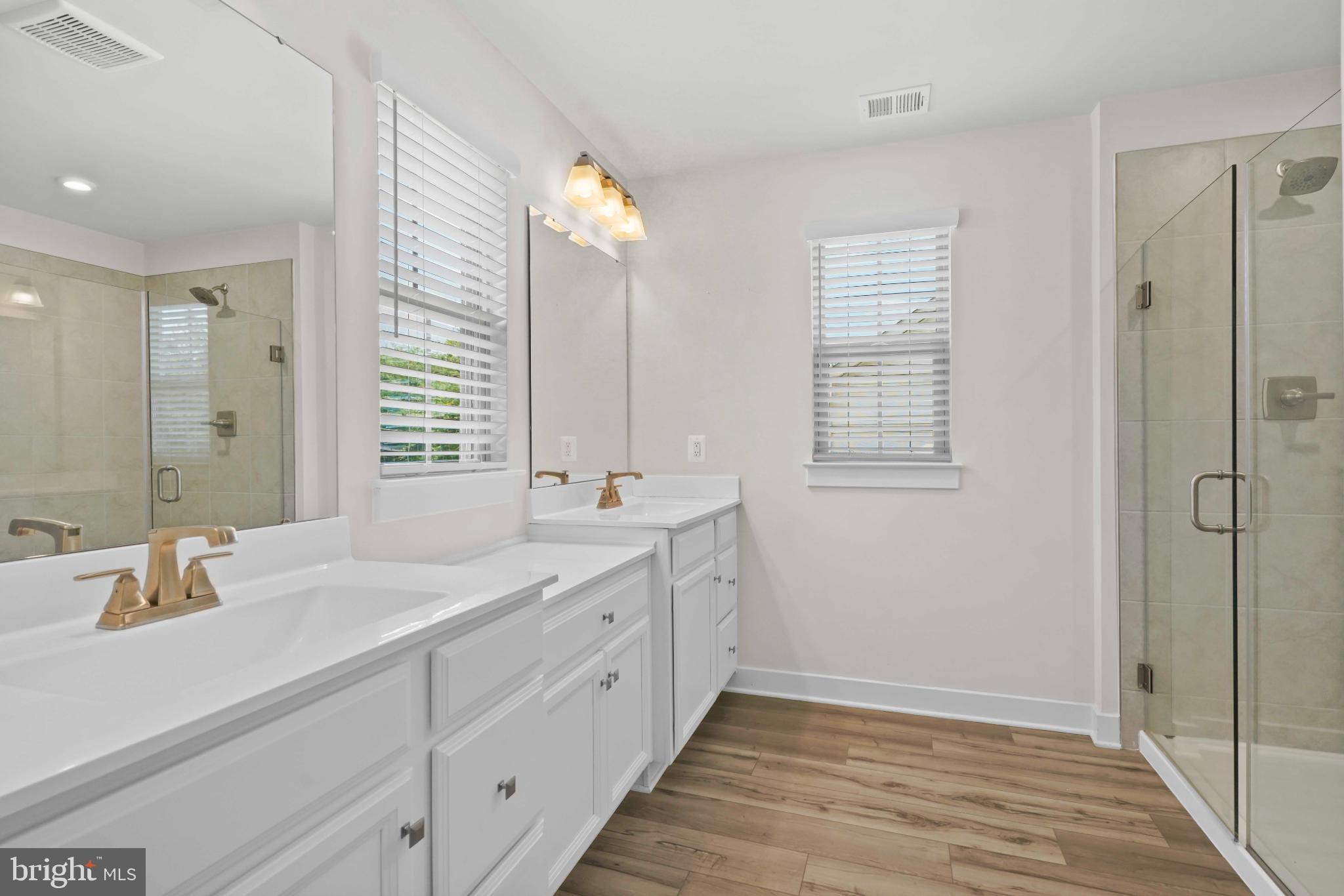 3903 Emory Ridge Road Brandywine, MD 20613 - Photo 20 of 43 a bathroom with double vanity sink a mirror and a shower