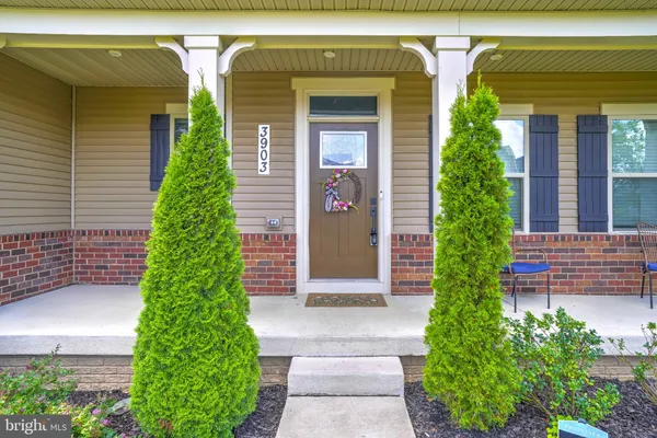 a view of a house with a backyard porch and sitting area