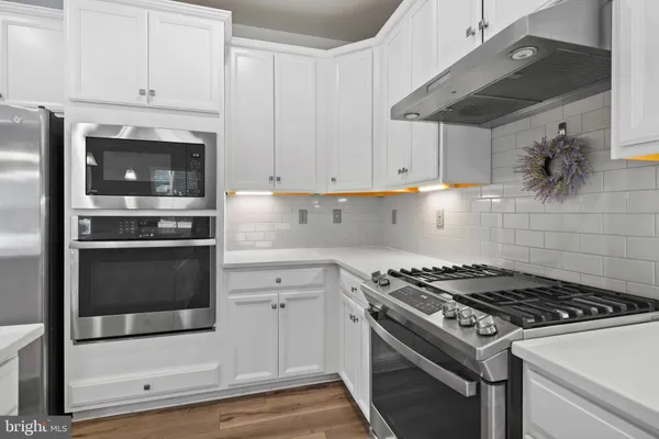 a kitchen with a stove a sink and a microwave