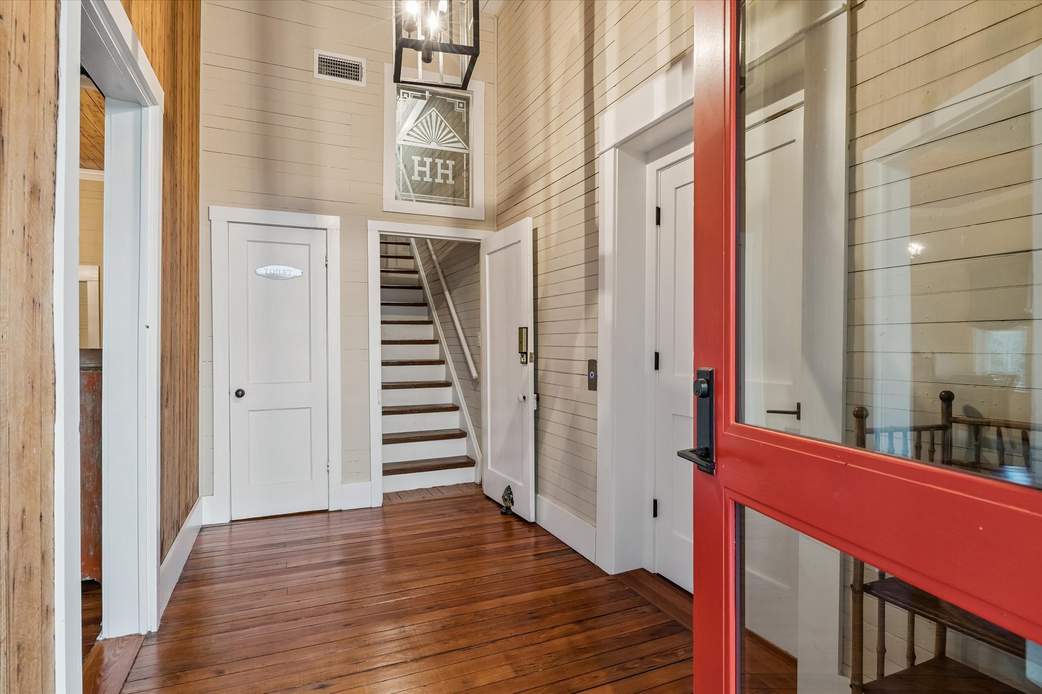 895 South Weyand Road Round Top, TX 78954 - Photo 11 of 37 a view of a hallway with wooden floor and staircase